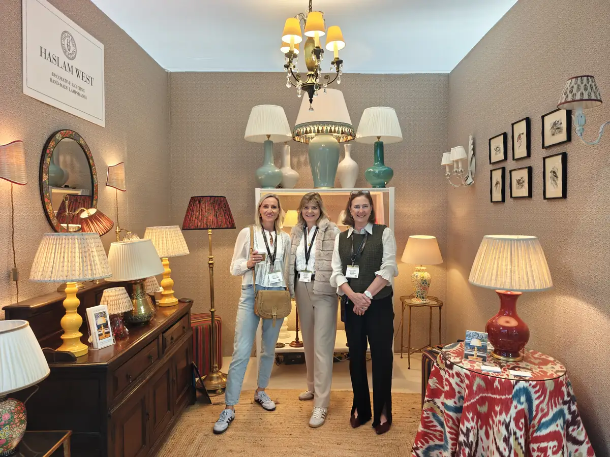 Lucy Kelvie with the Haslam West team on their stand of handmade pleated lampshades and ceramic table lamps at Decorex 2026